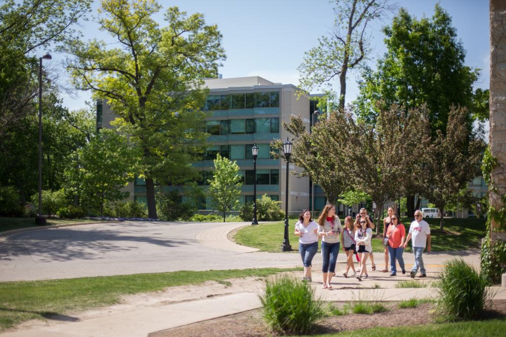 A student ambassador gives a campus tour to prospective students.