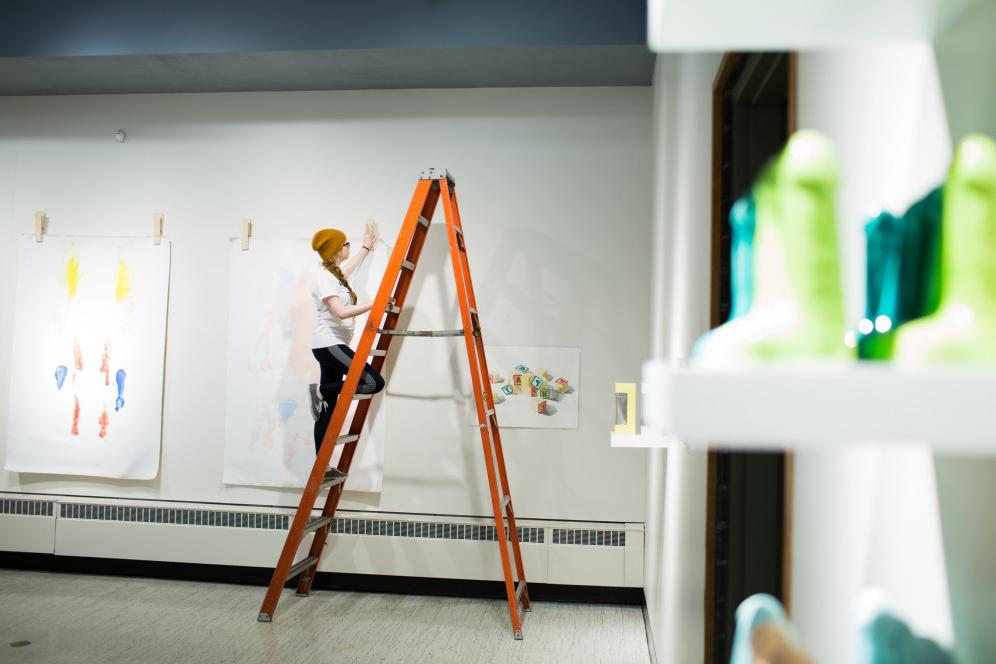 A gallery assistant builds an exhibition in the H. F. Gallery of Art.