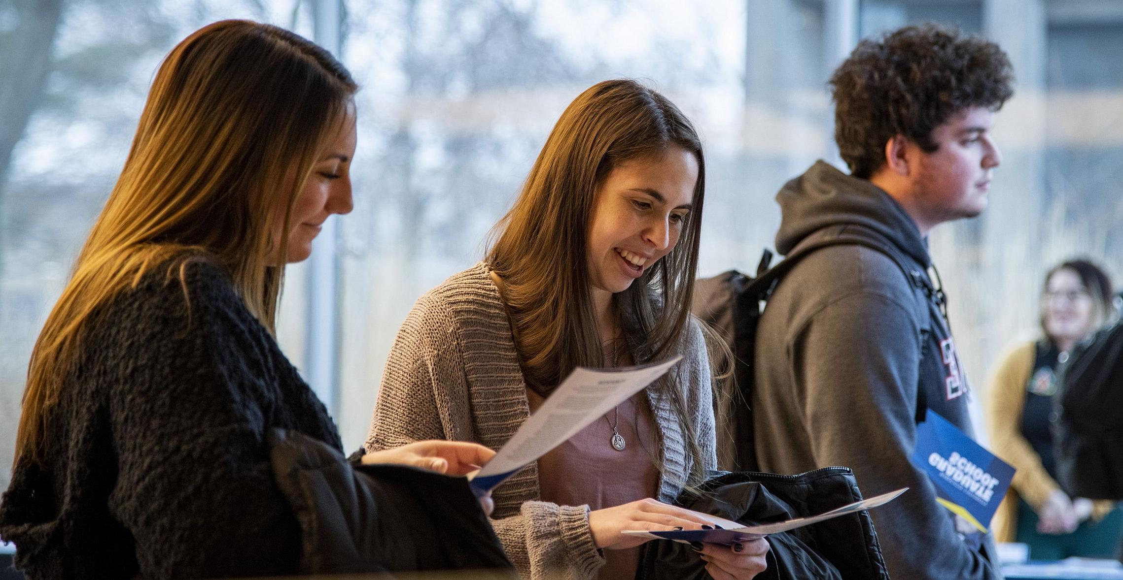 Students look at brochures at the Pre-Health Fair.